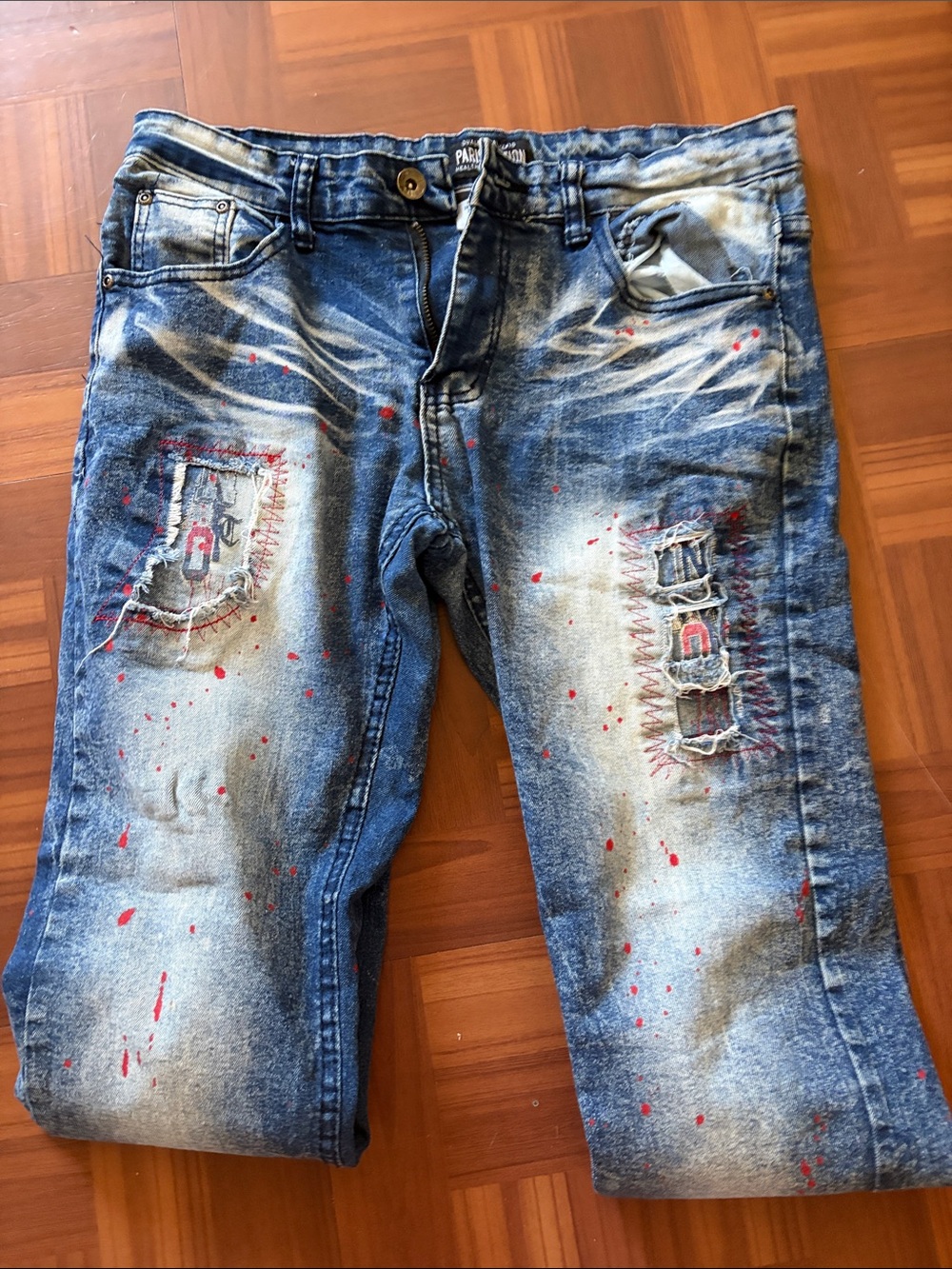 Men's Distressed Blue Denim Jeans with Red Paint Detail